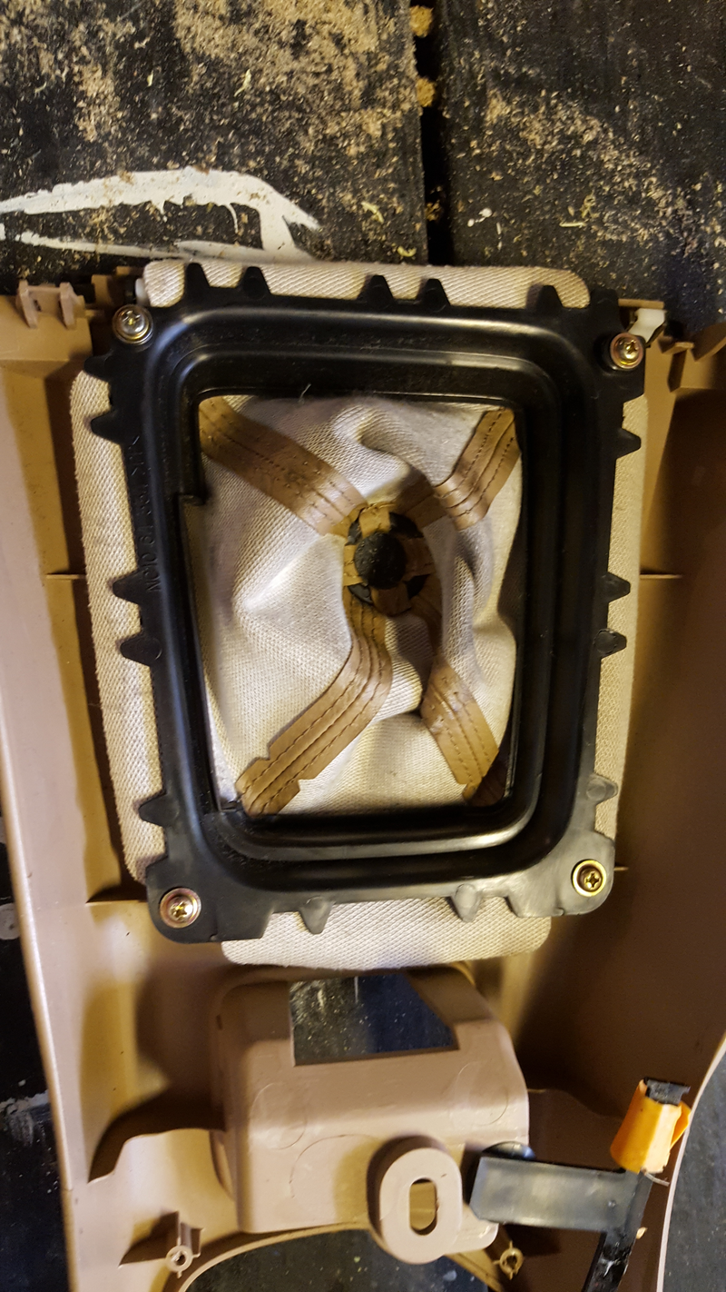 Four screws hold the shifter boot in place from the bottom